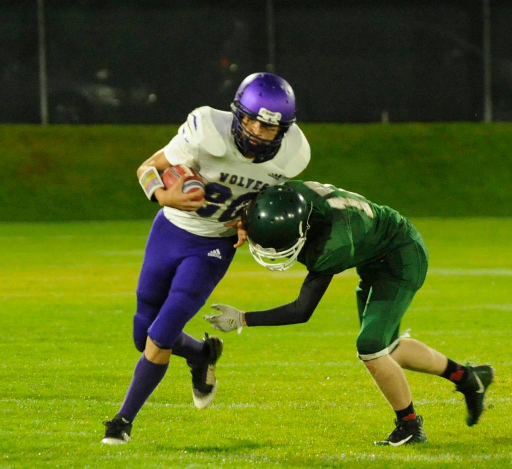 Sequim receiver Isaiah Moore, left, looks to shrug off a tackle by Port Angeles defensive back Miles Van Sant in the first half of the Wolves 26-0 win at Port Angeles on Oct. 18. Sequim Gazette photo by Michael Dashiell