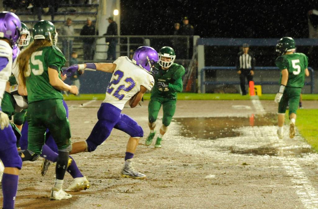 Sequim running back Walker Ward bursts through the line for a score in the second quarter of the Wolves big win at Port Angeles on Oct. 18. Sequim Gazette photo by Michael Dashiell