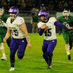 With Brandon Barnett (55) leading the way, Sequim quarterback Taig Wiker picks up a big gain in the first quarter of the Wolves league match-up at Port Angeles on Oct. 18. Sequim Gazette photo by Michael Dashiell