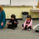 Helen Haller music teacher Laura Lorentzen leads first graders in a series of spirited exercises as they master holding rhythm sticks. Students include, from left, Sage Trejo, Shanty Gallegos-Figueroa and Mason Lopez Farrell, all students from Gwen Rudzinskis class. Photo by Patsene Dashiell