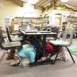 Fourth-graders at Halen Haller Elementary School take cover under library tables as Great Washington Shake Out earthquake drill begins. Photo by Patsene Dashiell