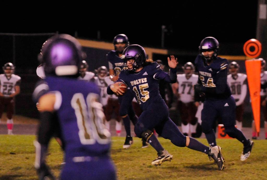 Sequim quarterback Taig Wiker cuts through the Hoquiam defense for a big gain. Sequim Gazette photo by Michael Dashiell