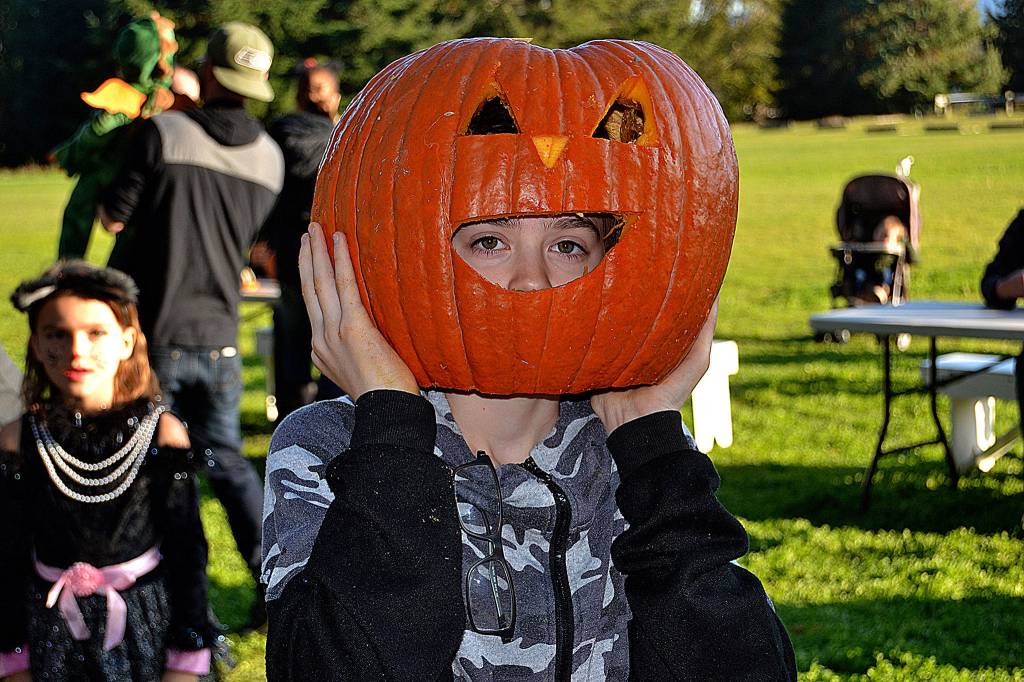 William Hamilton, 12, makes himself a mask for Halloween at the Sequim Prairie Granges pumpkin party. Sequim Gazette photo by Matthew Nash