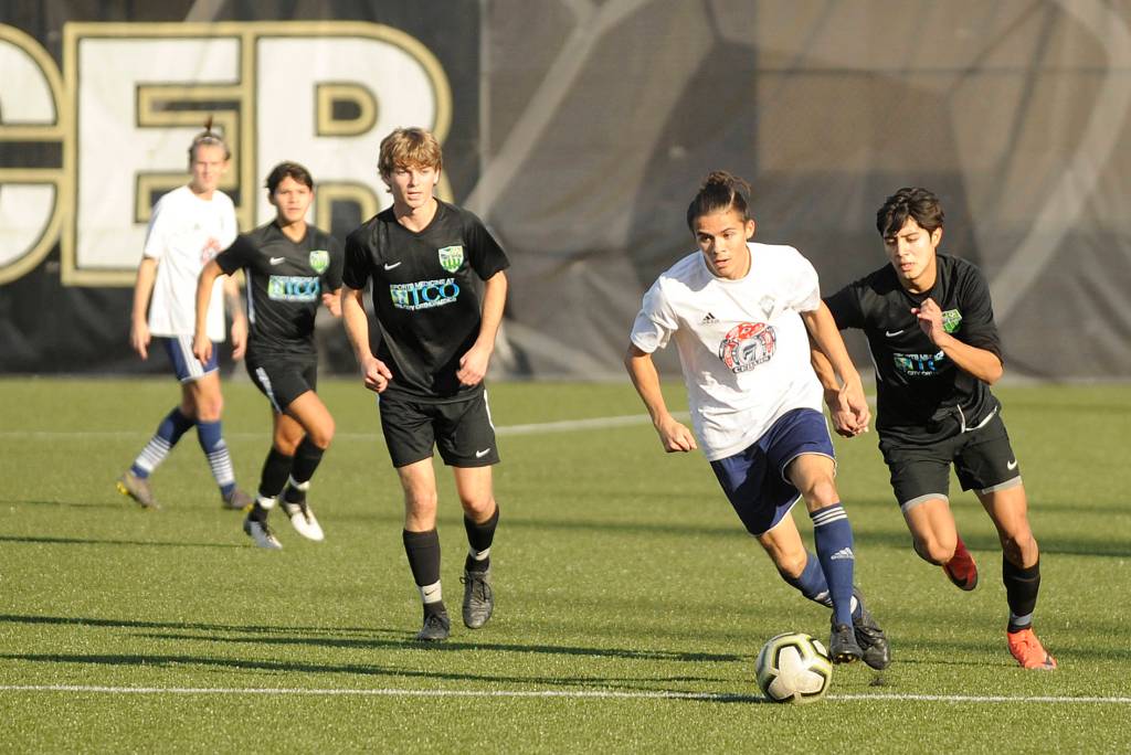 Sequim High senior Ryan Tolberd (second from right) looks for room to run as Storm King takes on Club Three Rivers in an RCL Division 2 match-up in Port Angeles on Nov. 2. Tolberd is one of six players with all-league honors on the Storm King squad. Sequim Gazette photo by Michael Dashiell