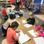 Melissa Novaks kindergarten class at Helen Haller Elementary work on personal narratives during a Writers Workshop. The topic of the day was their Halloween costumes and festivities. From left are Jaxson Kamprud, Lynn Westman, Thelo Crear, Linnea Mager, Atreus Parker, Rayna Buggy, Uriah Hollowell and Madelynn McIntyre. Photo by Melissa Novak