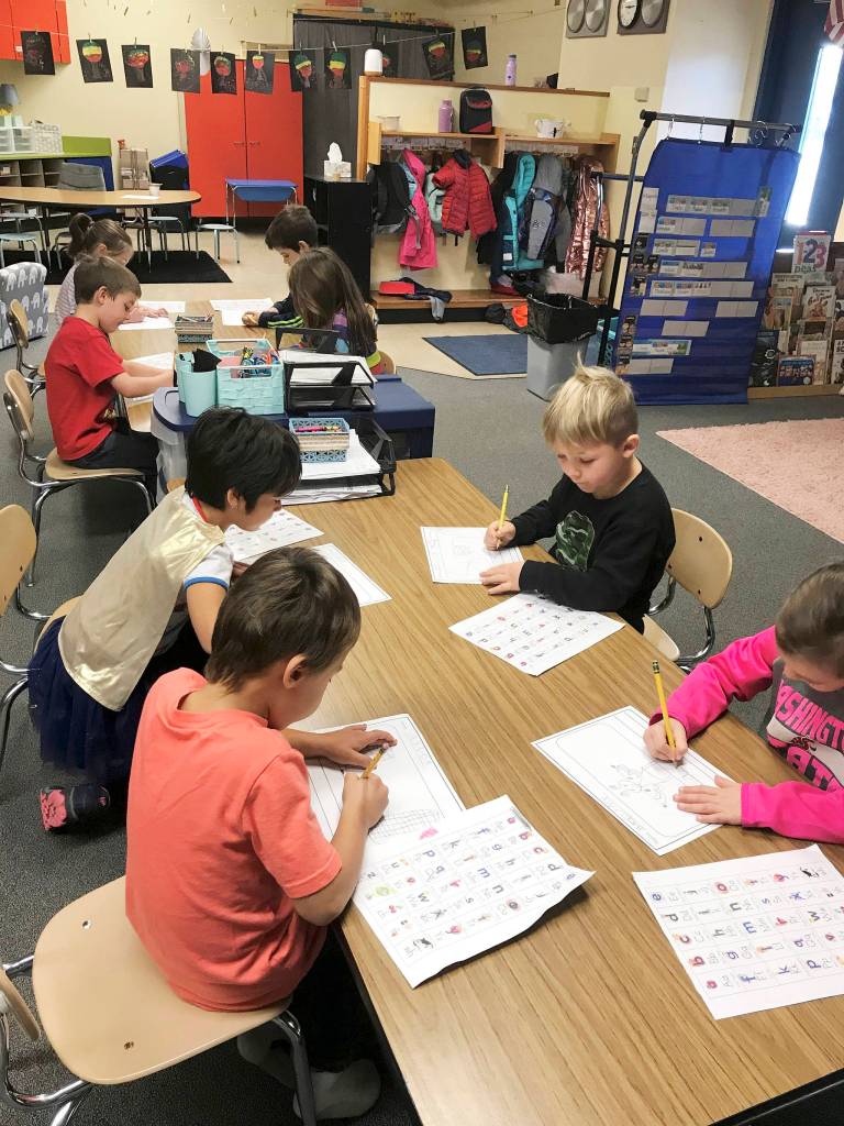 Melissa Novaks kindergarten class at Helen Haller Elementary work on personal narratives during a Writers Workshop. The topic of the day was their Halloween costumes and festivities. From left are Jaxson Kamprud, Lynn Westman, Thelo Crear, Linnea Mager, Atreus Parker, Rayna Buggy, Uriah Hollowell and Madelynn McIntyre. Photo by Melissa Novak