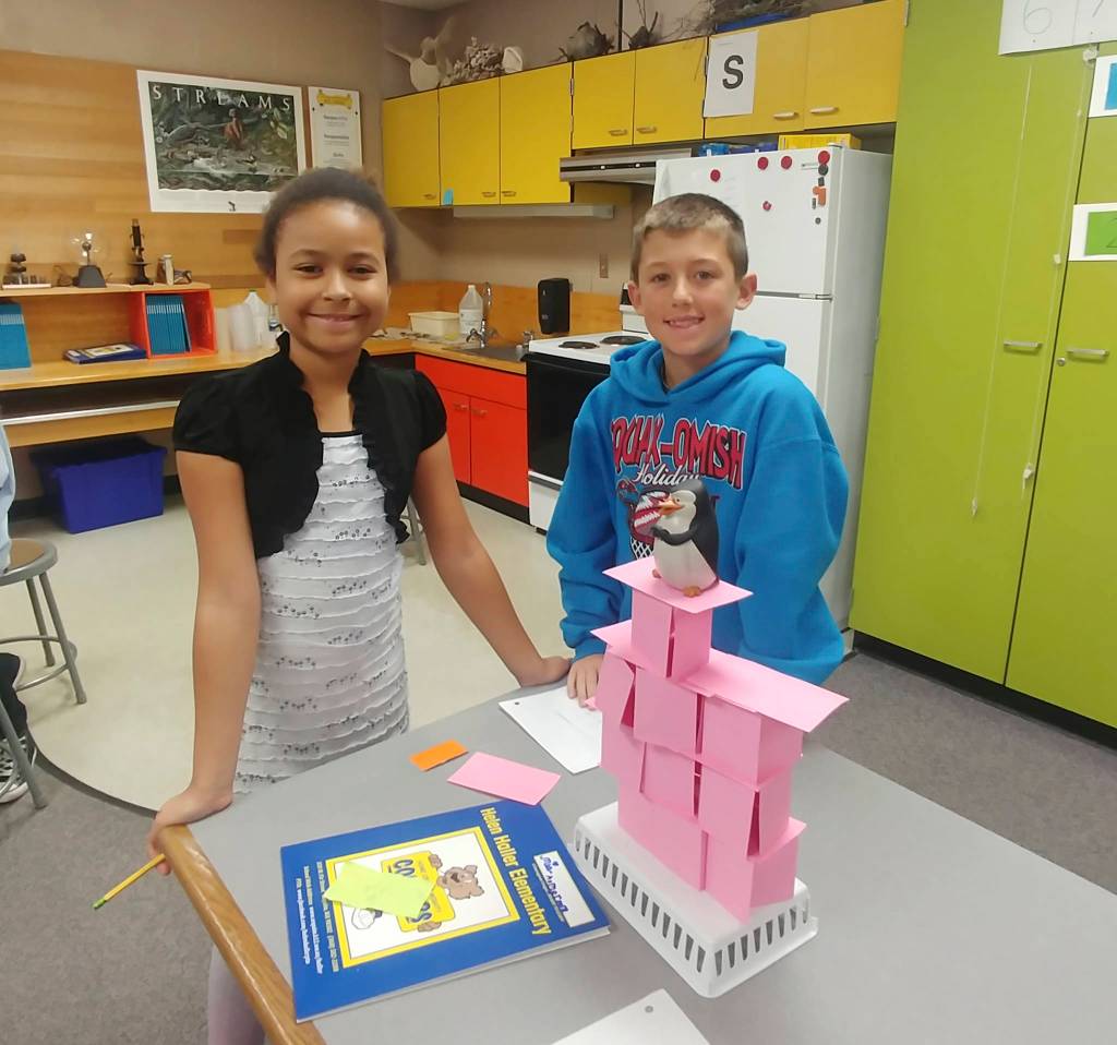 Helen Haller fourth graders Mia Peralta and Nolan Bacchus build an index card tower that is able to support the weight of the object placed atop. Photo by Kieth Lee