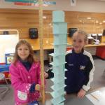Helen Haller third-graders Annie Sorensen, left, and Elizabeth Grimes measure the height of their index card tower. Photo by Kieth Lee
