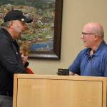 Mayor Dennis Smith greets Robb Neal and his grandson Brody Neal on Oct. 28 after reading a resolution honoring longtime city clerk Karen Kuznek-Reese. She was unable to attend a ceremony renaming the Civic Center Gallery after her due to receiving treatment in the hospital. Sequim Gazette photo by Matthew Nash