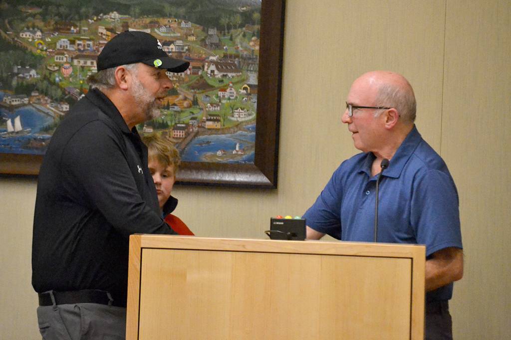 Mayor Dennis Smith greets Robb Neal and his grandson Brody Neal on Oct. 28 after reading a resolution honoring longtime city clerk Karen Kuznek-Reese. She was unable to attend a ceremony renaming the Civic Center Gallery after her due to receiving treatment in the hospital. Sequim Gazette photo by Matthew Nash