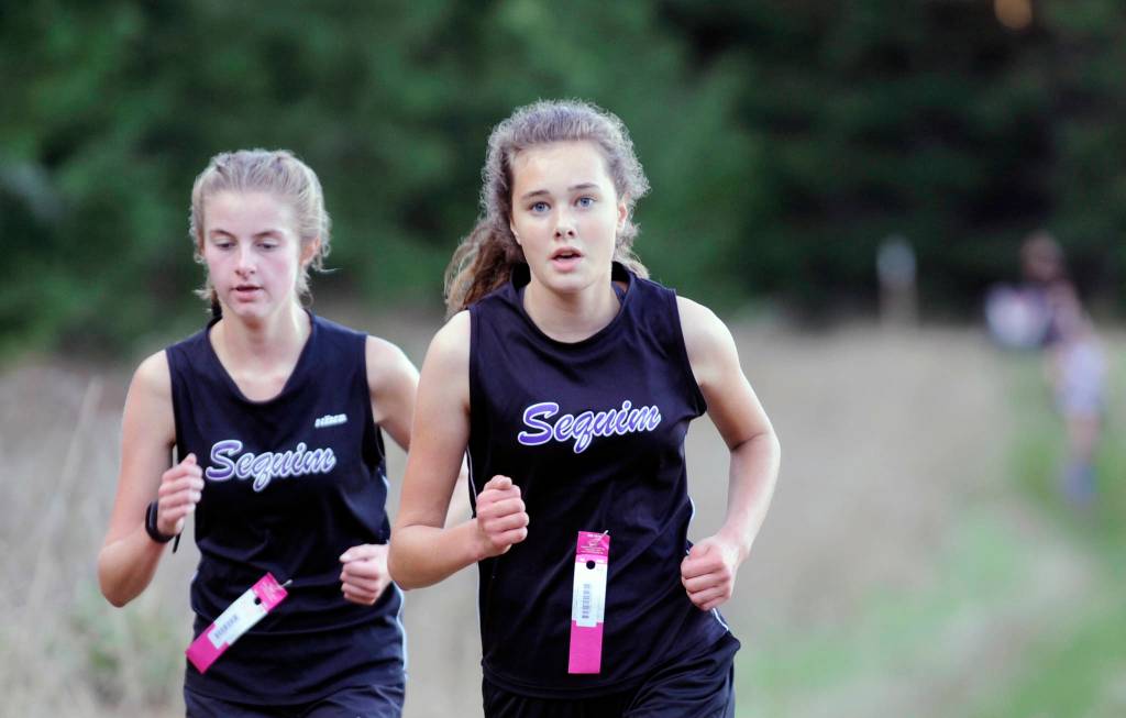 Sequims Jessica German, left, and Anastasia Updike earned berths at the State 2A cross country final in Pasco this weekend after finishing in the top 30 at the Westside Classic district meet on Nov. 2. Below, Sequim junior Eli Gish, pictured here at an Olympic League meet earlier this season, took 34th overall at the West Central District 3 meet and makes a return trip to the state 2A cross country final in Pasco this week. Gish qualified with the Wolves as a freshman in 2017. Sequim Gazette file photos by Michael Dashiell