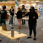Patrons try virtual reality machines at the Port Angeles Library. Virtual reality technology sessions are set for November and December at Sequim and Port Angeles library branches. Photo courtesy of North Olympic Library System