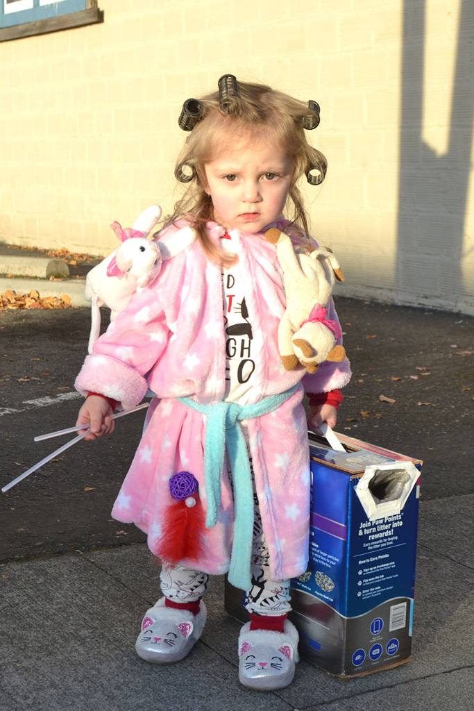 Elizabeth Treece, 2, returned to trick or treat downtown Sequim as a crazy cat lady this year.