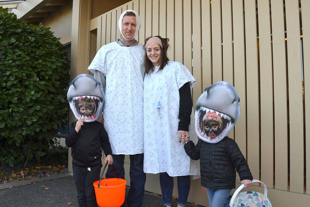 The Bekkevar family might need a bigger boat with little sharks Wyatt, 4, and Paisley, 3, leading their parents/victims Nelson and Christine Bekkevar on Halloween. Sequim Gazette photo by Matthew Nash