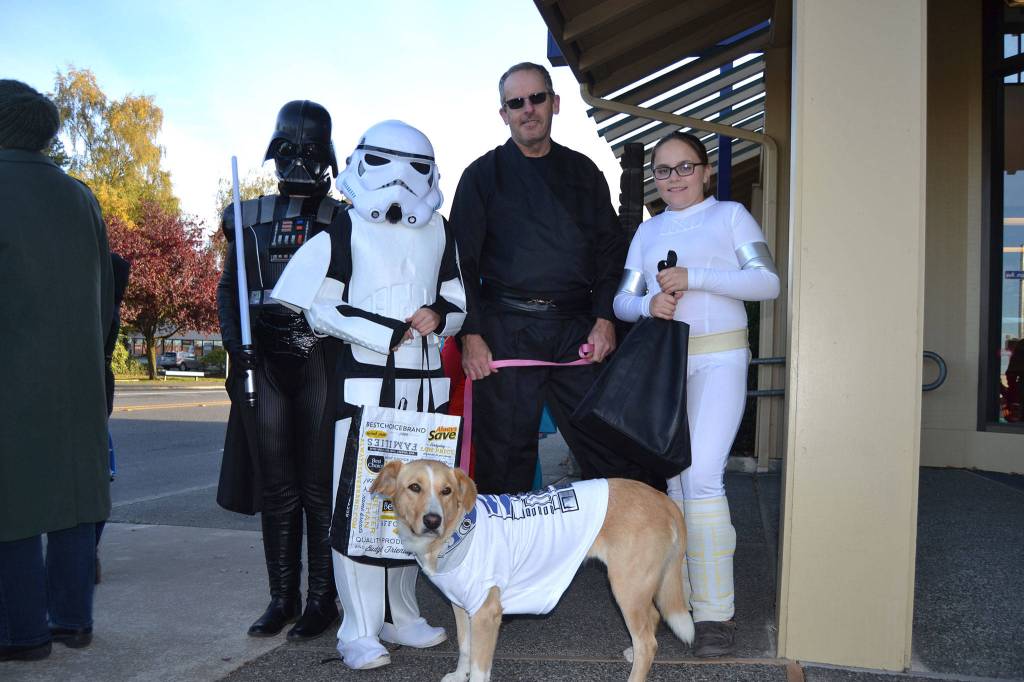 A family that uses the force together, trick or treats together like the Edwards crew, from left, Carolee, Penny, 12, Harold, Patience, 12, and Potato the dog.