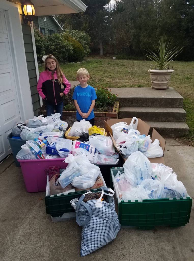 Donations tend to add up for River Jensens project to provide toiletry bags to those in-need across Clallam County. Here she stands with her brother Canyon with some donations in recent years. Photo courtesy of Anna Jensen