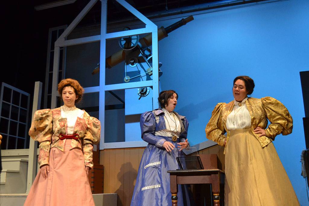 Cast and crew for Silent Sky said women have been often overlooked for their contributions to our society, such as Henrietta Leavitt (Ginny Holladay Jessee), middle, discovering how to measure distances between stars. Here Henrietta meets her new coworkers Annie (Tia Stephens), left, and Willamina (Marissa Wilson) in the Harvard Observatory. Right, Ginny Holladay Jessee, as Henrietta Leavitt, looks at a photograph of space on a glass plate with her boss apprentice Matt Forrest, as Peter Shaw, in the Harvard Observatory. Leavitt helped discover how to measure the distance between galaxies despite women being prohibited from certain duties such as looking directly through a telescope. Sequim Gazette photos by Matthew Nash