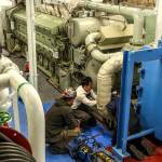 Crews work to replace and refit a water filter system aboard the MV Puyallup at the Eagle Harbor Maintenance Facility on Bainbridge Island last Thursday. (Kevin Clark/Everett Herald)