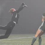 Sequim Wolves goalkeeper Olivia Hale (left) parries a long shot away while Port Angeles Roughriders star Millie Long (right, 10) lurks near goal during their District 3 playoff tournament match at Peninsula College on Nov. 9. Port Angeles won 1-0 thanks to a goal from Long, but the Wolves had already qualified for the 2A state playoffs. Sequim Gazette photo by Conor Dowley