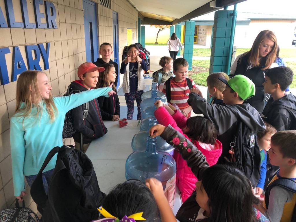 Student Council members (from left) Milla Rajala-Bruner, Nathanael Updike, Genevieve Wakefield, Ryan Weidman and Marelys Gonzalez assist students during Helen Haller Elementarys third-annual Penny Wars on Nov. 8. The council raised more than $600 that will go to supporting school-wide events and improving playground equipment for the 2019-2020 school year. Photo by Meredith Vincent