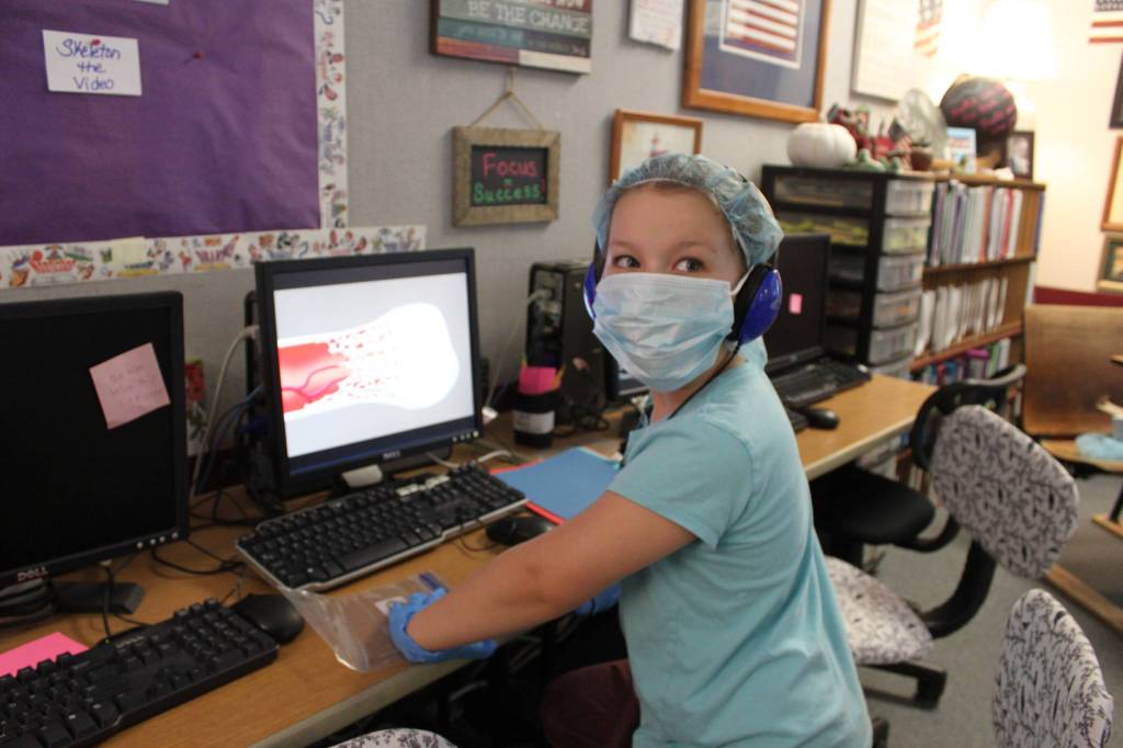 Greywolf teacher Sheri Burke joins students J.D. Kessler, Drake Cambell and Lucien Wolfley in a recent lesson in medicine. Photo by Darcy Lamb
