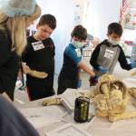 Above, Greywolf Elementary third-grader Addisyn Tate checks out x-rays during a recent classroom project. Below, Greywolf teacher Sheri Burke joins students J.D. Kessler, Drake Cambell and Lucien Wolfley in a recent lesson in medicine. Photos by Darcy Lamb