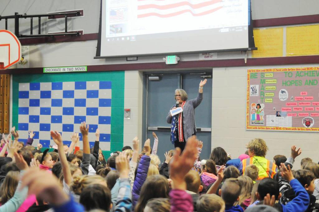 Greywolf Elementary principal Donna Hudson asks students if they have military veterans in their families at last weeks Veterans Day assembly.