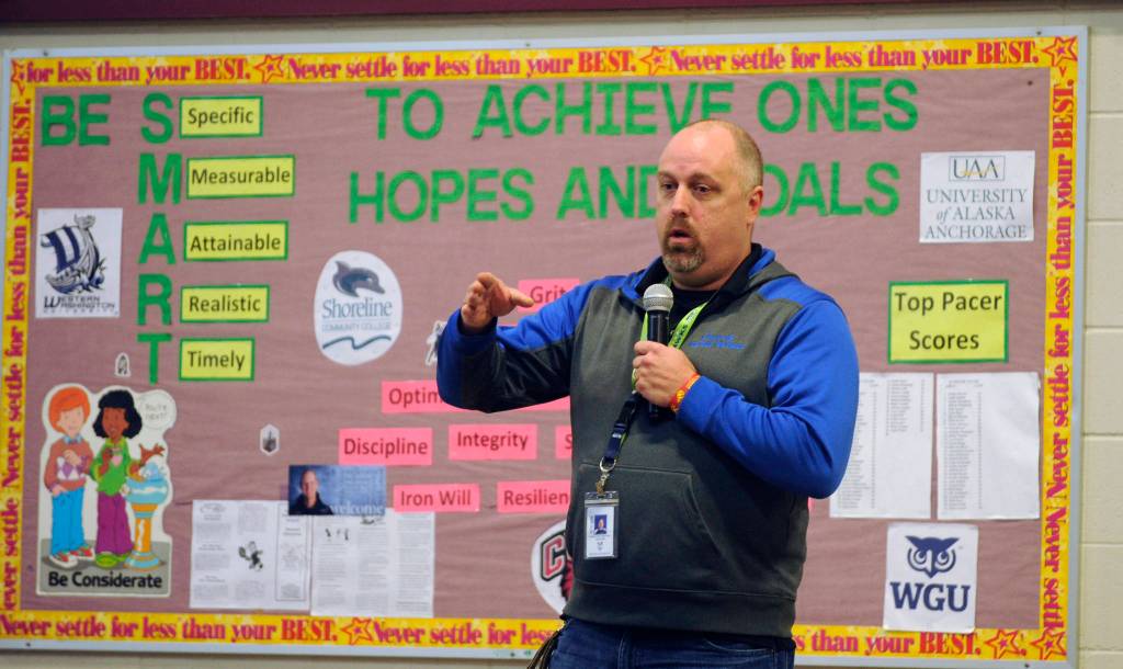 Gregory Newton, a teacher at Greywolf Elementary School, talks with students about his experience in the U.S. Marine Corps at the schools annual Veterans Day assembly on Nov. 8. Newton, who was raised in Sequim (he went to Helen Haller Elementary School) he served for six years in the Corps, urged students last week to remember to work hard, play hard, be honest and be kind. Sequim Gazette photo by Michael Dashiell