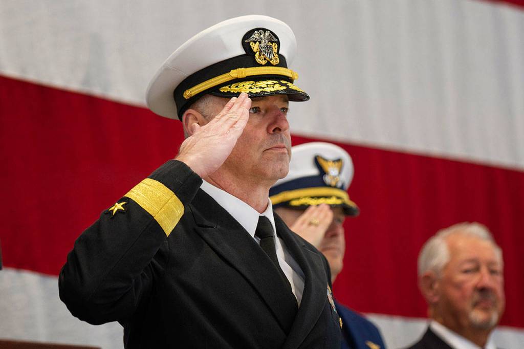 Rear Adm. Christopher Scotty Gray of the U.S. Navy salutes during the national anthem at the Veterans Day ceremony at U.S. Coast Guard Air Station/Sector Field Office Port Angeles on Monday. (Jesse Major/Peninsula Daily News)