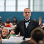 Doug Gailey directs the Port Angeles High School Band during the Veterans Day ceremony at U.S. Coast Guard Air Station/Sector Field Office Port Angeles on Monday. (Jesse Major/Peninsula Daily News)