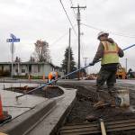 Tim Coville, foreground, and Peter Gish work on sidewalks along West Fir Street on nov. 12. The citys biggest current project at $3.4 million, the projects completion is tentatively slated for late spring, city staff said. Sequim gazette photo by Michael Dashiell