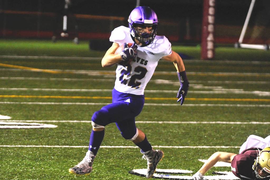 Sequim Wolves running back Walker Ward looks for space in the first quarter against the Lakewood Cougars in the 2A state playoffs on Nov. 15. Ward ran for 168 yards and a touchdown on the night, but the Wolves lost 38-12. Sequim Gazette photo by Conor Dowley