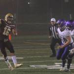 Lakewood Cougars quarterback Jared Taylor throws on the run with Sequim Wolves defensive linemen Mitchell Horton (second from right) and Austin Newton (right) in pursuit during the second quarter of the Cougars 38-12 win over the Wolves in the 2A state playoffs on Nov. 15. Sequim Gazette photo by Conor Dowley