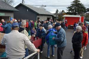 Volunteers stuff 800 bags for food bank’s Thanksgiving