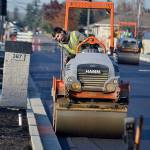 Zach Dulik with Lakeside Industries smooths out a portion of Fir Street on Nov. 22 as the initial overlay goes down in front of Helen Haller Elementary. Sequim Gazette photo by Matthew Nash