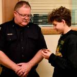 Deputy Fire Chief Justin Grider has his badge pinned on by his son Charlie on Nov. 19 at the Clallam 2 Fire Rescue board meeting. Submitted photo