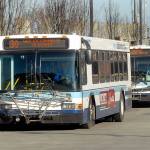 A pair of Clallam Transit buses board passengers at The Gateway transit center in downtown Port Angeles on Thursday. (Keith Thorpe/Peninsula Daily News)