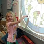 Kindergardener Sarina Whitteker selects Apologize from Kelsos Choices to help mend hurt feelings in a difficult situation. Photo by Patsene Dashiell
