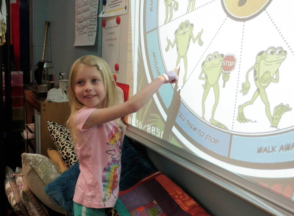 Kindergardener Sarina Whitteker selects Apologize from Kelsos Choices to help mend hurt feelings in a difficult situation. Photo by Patsene Dashiell