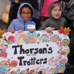 Second-graders Faith Eaton and Brodie Chatski proudly display their class sign at the beginning of Helen Haller Elementarys Turkey Trot on Nov. 27. Photo by Patsene Dashiell