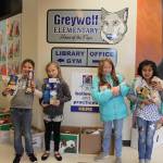 Greywolf Elementary students (from left) Skyler Flamand, Winter Rose Keend, Kaylee Lawson and Analee Rodriguez display some of the food collected by students during the recent Greywolf CARES! 12 days of Giving. Photo by Darcy Lamb
