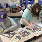 Fourth-graders Carter Endicott and Katie Simpler work on their stained glass art project.