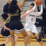 Keith Thorpe/Peninsula Daily News Peninsulas Casandra White, right, looks for a way around the defense of Shorelines Raelyn Kimmel, left, and Clara Hansen in the third quarter on Wednesday in Port Angeles.