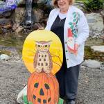 Marilynn Elliott displays whimsical Halloween and Christmas pieces she made from plywood and driftwood for her garden. Photo by Betty Harriman