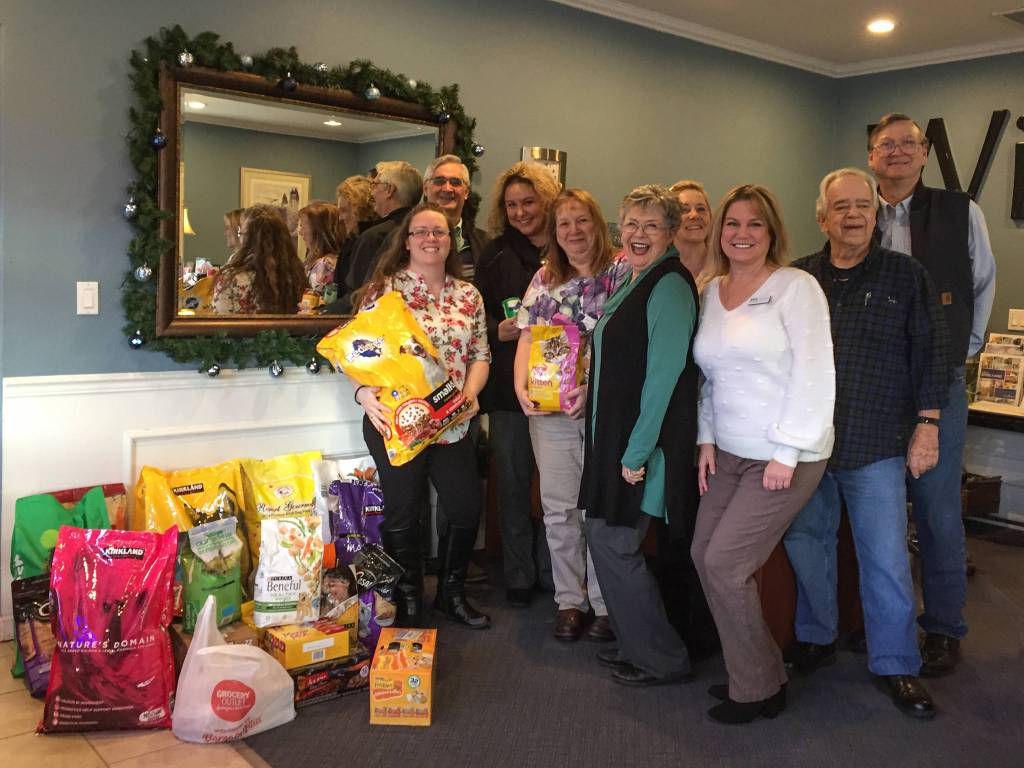 Above left: Santa Paws (Rick Brown) snuggles up with a couple of canines during Windermere Real Estates pet photo opportunity on Nov. 22.                                Above right: Second from right Nicole Patrick, development manager for the Olympic Peninsula Humane Society, stops by a Windermere Real Estate office to pick up donations from Windermeres Pet Food Drive in November. The three local Windermere offices gathered 285 pounds of pet food and treats along with some toys and dental spray. Many of the donations, Windermere representatives said, came in during the companys photo shoot with Santa Paws (Rick Brown) on Friday, Nov. 22. Pictured, from left, are Windermere office manager Jessica Warriner, Tyler Conkle, director of operations Dollie Sparks, Sheryl Payseno Burley, Carolyn Dodds, Michelle Gulka; Patrick, branch managing broker Dave Sharman and Robert Dodds. Photo courtesy of Windermere Real Estate