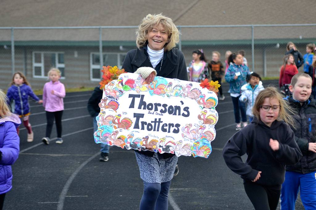 Second grade teacher Teresa Thorson walks the track with her class during Helen Hallers Turkey Trot. She and other teachers took laps with their students in support of the Six Books for Summer program. Sequim Gazette photo by Matthew Nash