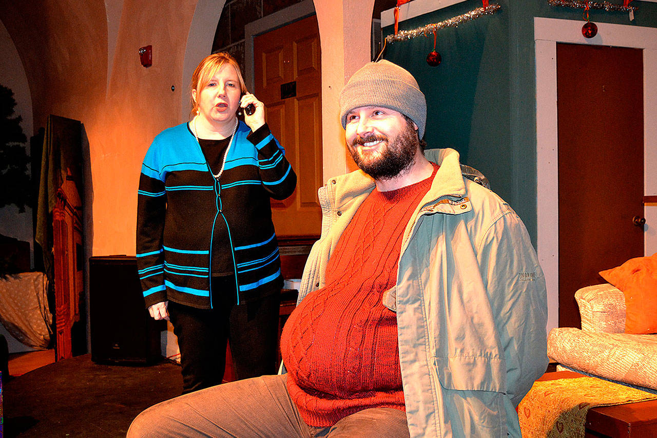 Karol (Christy Holy) calls the police on the Guy (E.J. Anderson III) as she discovers him in her house for Another Night Before Christmas. Through odd fate, the two are stuck together throughout the musical. Sequim Gazette photo by Matthew Nash