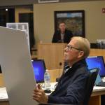 City councilor William Armacost looks at designs for the proposed Lavender Meadows development. He and other city councilors expressed concern about the potential of rising rents for the manufactured homes park. Sequim Gazette photo by Matthew Nash