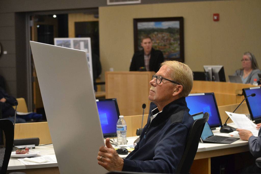 City councilor William Armacost looks at designs for the proposed Lavender Meadows development. He and other city councilors expressed concern about the potential of rising rents for the manufactured homes park. Sequim Gazette photo by Matthew Nash