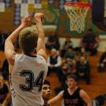 Erik Christiansen, pictured shooting a three pointer against the Neah Bay Reds on Dec. 4, scored 28 points that night after scoring 13 during the teams season opener against Klahowya on Dec. 2. Sequim Gazette photo by Conor Dowley